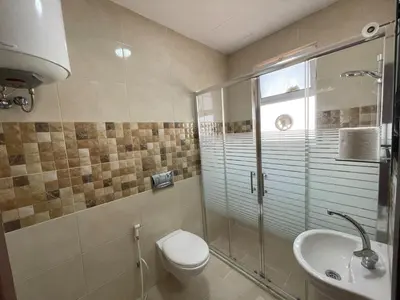 a bathroom with a toilet and a sink at Modern 2-Bedroom Apartment in a Vibrant Neighborhood in Amman