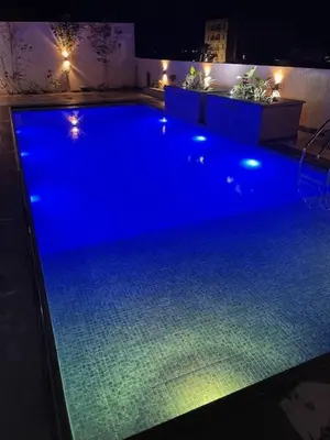 a large pool with blue lights in a room at Deadsea Elite second floor shared swimming pool in Sowayma