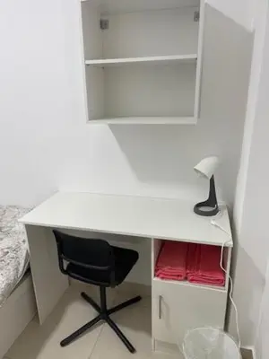 a white desk with a chair and a lamp at Deadsea Elite second floor shared swimming pool in Sowayma