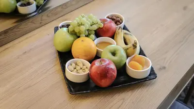 a tray of fruits and nuts on a table at Sandy palace Hotel in Amman