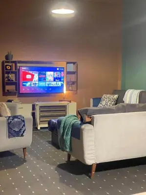 a living room with couches and a flat screen tv at 3bedrooms apt near paris square in Amman
