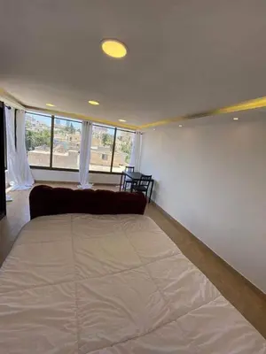 a large bed in a room with a couch at The view III in Amman
