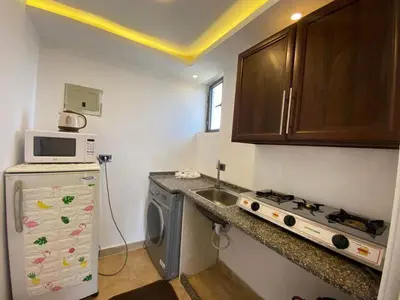 a small kitchen with a sink and a microwave at The view III in Amman