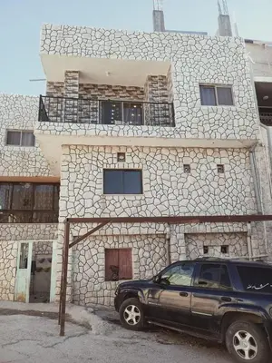 a black suv parked in front of a building at Margaret from Petra cave house in Wadi Musa