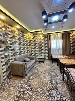 a living room with a couch and a table at Margaret from Petra cave house in Wadi Musa