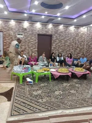 a group of people sitting around tables in a room at Margaret from Petra cave house in Wadi Musa