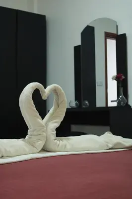 a swan made to look like a heart on a bed at Value Place in Wadi Musa