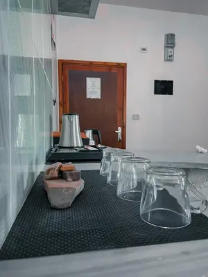 a row of glass vases sitting on a table at Value Place in Wadi Musa