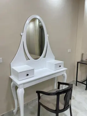 a white dressing table with a mirror and a chair at Airport Villa Amman in Amman