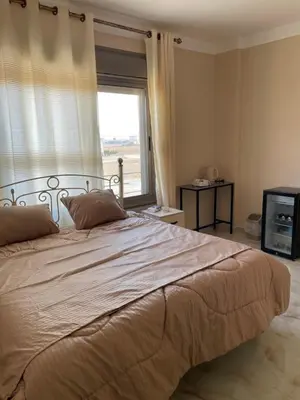 a bedroom with a large bed with a window at Airport Villa Amman in Amman