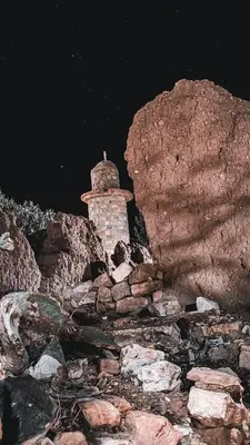 a stone lighthouse sitting on top of a rocky mountain at Dana Star lodge in Dana