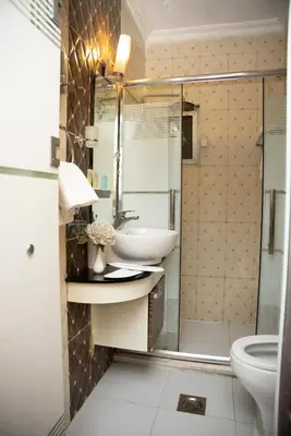 a bathroom with a sink and a shower at Sama Paris Plaza Hotel in Amman