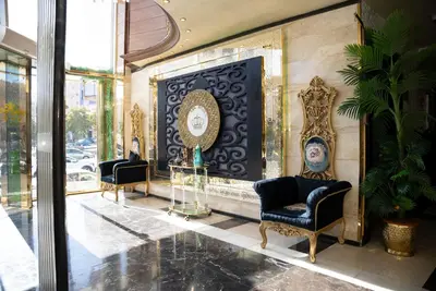 a lobby with two chairs and a fireplace at Sama Paris Plaza Hotel in Amman