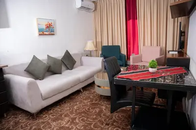 a living room with a couch and a table at Sama Paris Plaza Hotel in Amman