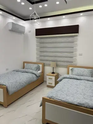 a bedroom with two beds and a window at Third circle Luxury Hotel apartment in Amman