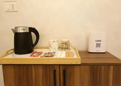 a coffee maker sitting on top of a wooden table at Third circle Luxury Hotel apartment in Amman
