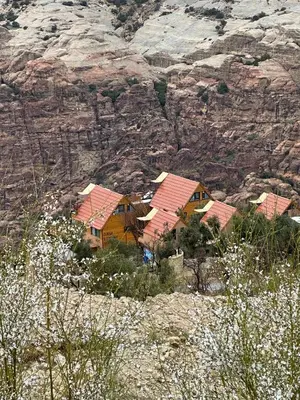 a group of houses on top of a mountain at Dana luxury huts in Dana