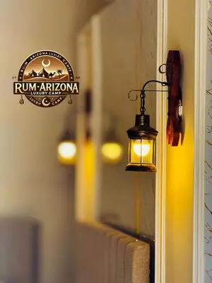 a lamp on a wall with a sign on it at RUM ARIZONA lUXURY CAMP in Wadi Rum