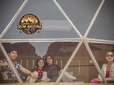 a group of people are sitting in a pyramid at RUM ARIZONA lUXURY CAMP in Wadi Rum