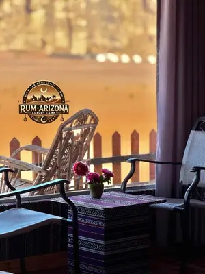 a vase of flowers sitting on a table on a balcony at RUM ARIZONA lUXURY CAMP in Wadi Rum