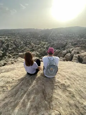 a man and a woman sitting on top of a mountain at Dana Village Lodge in Dana
