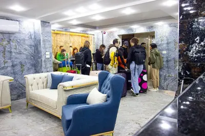 a group of people standing in a room with a couch at Beirut Hotel 2 in Amman