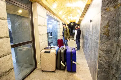 a group of people with their luggage in a hallway at Beirut Hotel 2 in Amman