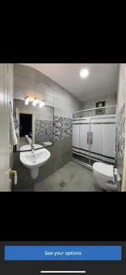 a bathroom with two sinks and a toilet at Petra Heaven Boutique in Wadi Musa