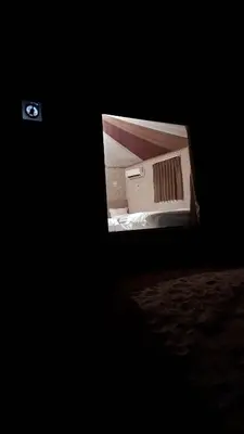 a television in a dark room with a box at Enjoy Camp Bubble Luxury with Jeep Tour in Wadi Rum