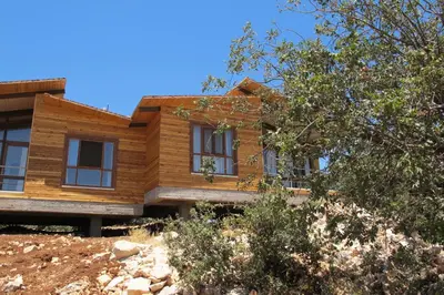 a wooden house on top of a hill at Ajloun Forest Reserve in Jerash