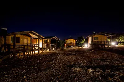 a group of houses at night with lights on at Ajloun Forest Reserve in Jerash