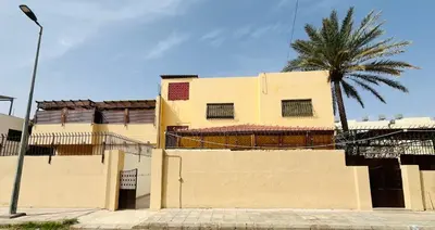 a building with a palm tree in front of it at marram apartment in Aqaba