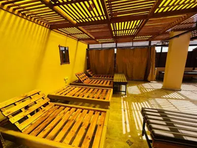 a room with several wooden benches in a building at marram apartment in Aqaba