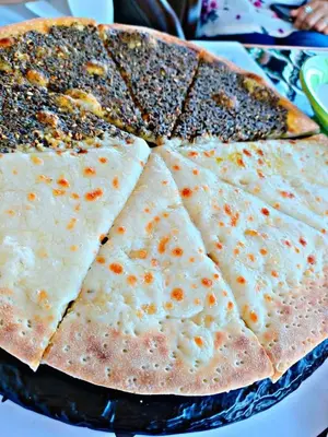 a close up of a pizza with four slices at Dana star in Dana