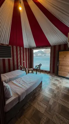 a bedroom with a large bed in a tent at Nada luxury camp in Wadi Rum