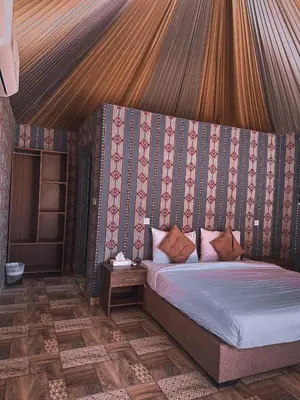 a bedroom with a bed in a tent at Nada luxury camp in Wadi Rum
