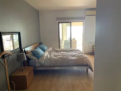 a small bedroom with a bed and a mirror at Horizon 2 Cozy Villa in Amman