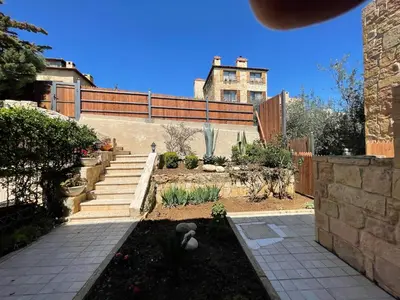 a garden with stairs and a house in the background at Horizon 2 Cozy Villa in Amman