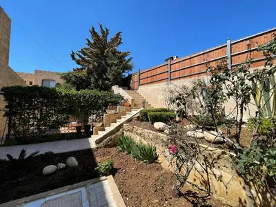 a garden with stairs and plants and a fence at Horizon 2 Cozy Villa in Amman