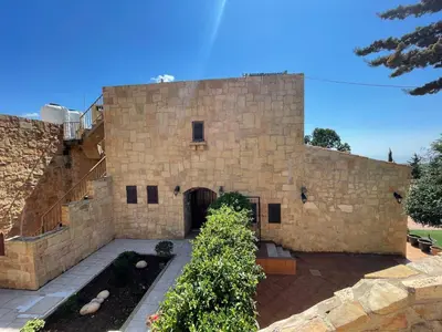 a large stone building with a courtyard in front of it at Horizon 2 Cozy Villa in Amman