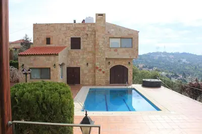 a house with a swimming pool in front of it at Horizon 2 Cozy Villa in Amman