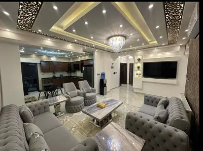 a large living room with couches and a table at شقق فندقية فاخرة in Amman