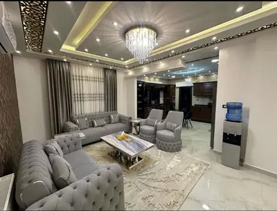 a living room with a couch and a table and chairs at شقق فندقية فاخرة in Amman