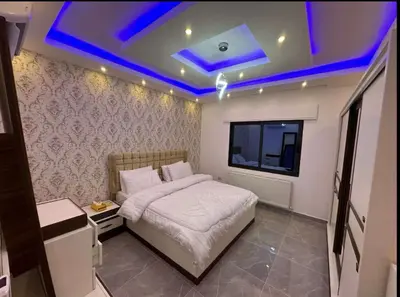 a bedroom with a bed and a tv in it at شقق فندقية فاخرة in Amman