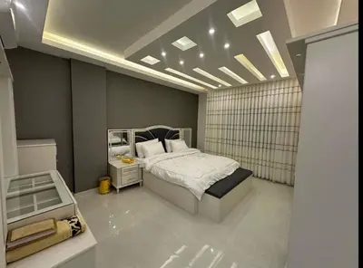 a bedroom with a bed and a mirror in it at شقق فاخرة حي الشميساني الأردن in Amman