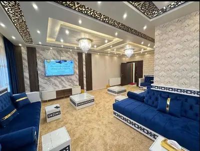 a living room with blue couches and a screen at شقق فاخرة حي الشميساني الأردن in Amman