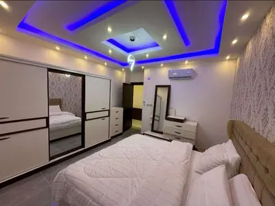 a bedroom with a large white bed and a blue ceiling at شقق فاخرة حي الشميساني الأردن in Amman