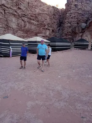 a group of people standing in the desert at Moon City Luxury Tent in Wadi Rum