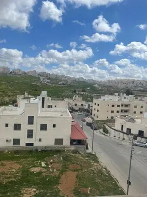 an aerial view of a city with buildings and a street at شقة مفروشة in Rujm Maghghijhah