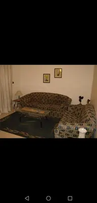 a living room with a couch and a coffee table at ستيديوهات مفروشة و مطلة في طابق ثالث و الرابع in Amman